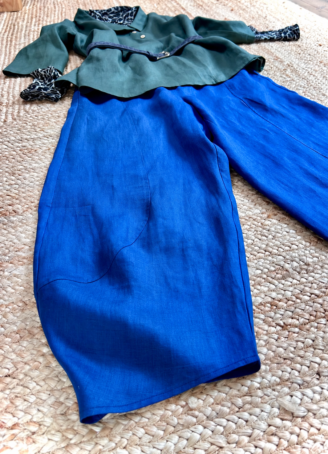 Close-up of the olive tunic with blue linen trousers